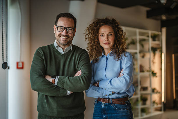 istock Business colleagues standing arms crossed in modern office 2250033608