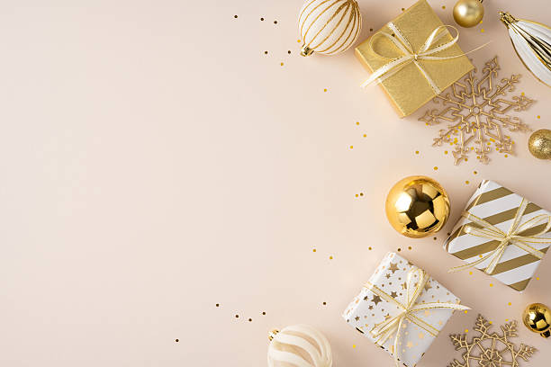 istock Soft beige background with wrapped presents, gold ornaments, and snowflake decor captures holiday spirit and festive mood for Christmas and New Year celebrations 2250033756