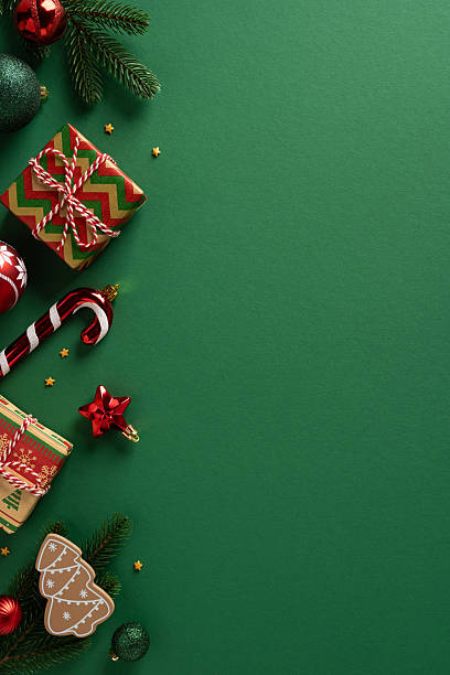istock A vertical festive flat lay with wrapped presents, candy canes, ornaments, and a gingerbread cookie on a green backdrop. Ideal for holiday campaigns, greeting projects, and seasonal marketing. 2250033767