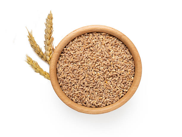 istock Wooden bowl with spelt grain isolated on white, top view 2250033887
