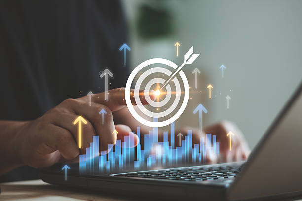 istock Person pointing digital target icon with virtual rising arrows and bar chart on laptop, symbolizing business growth, goal achievement, performance improvement, strategic success in modern analytics. 2250036389
