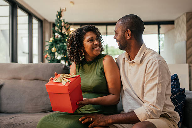 istock Husband gives wife a gift for Christmas. 2250036589