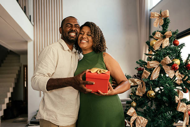 istock Husband gives wife a gift for Christmas. 2250036729