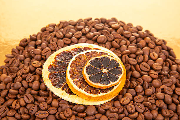 istock Warm coffee beans and dried orange slices on a reflective golden surface, creating a gourmet aesthetic for food styling. coffee aroma and taste citrus descriptors 2250036995