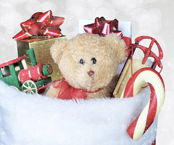 istock Christmas Stocking filled with toys - Bokeh Background with snow effect. 2250037553