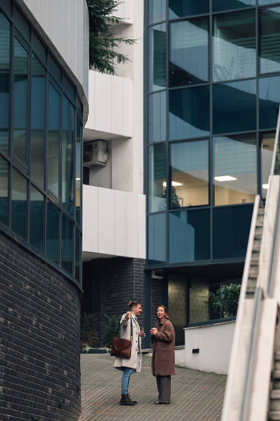 istock Colleagues collaborating and talking during coffee break in city 2250039706