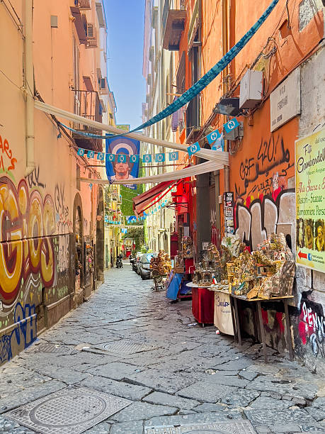 Naples, Italy - July 17, 2024: Vico Figurari, street where miniature statues are sold of religious nature and of famous people. 3-dimensional mountainous landscapes and Maradonna flag