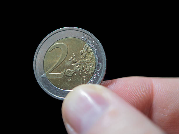 istock Two Euro Coin Close-Up Against Black Background 2250041029