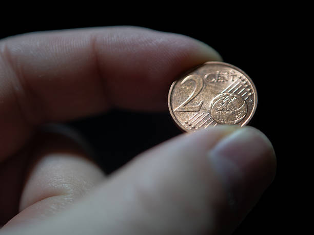 istock Holding a Two-Cent Euro Coin with Fingers 2250041061