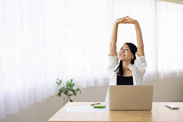 istock Woman Stretching During Work Break at Desk 2250042577