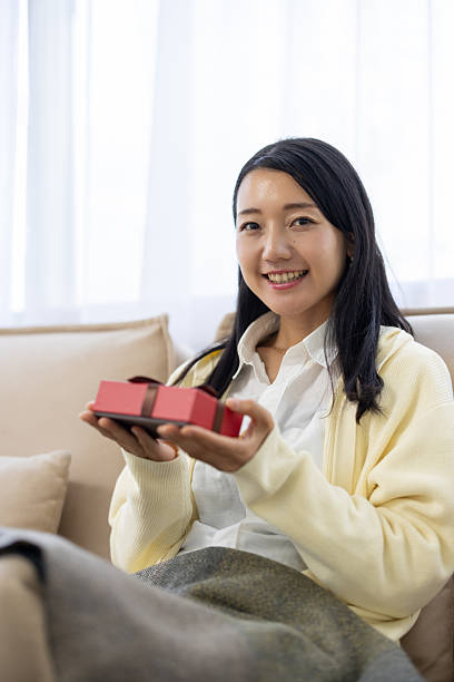 Woman Smiling with Gift Box on Hands