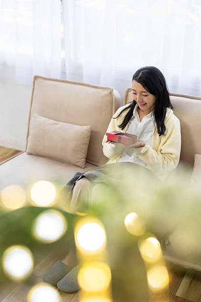 Woman Smiling with Gift Box on Hands