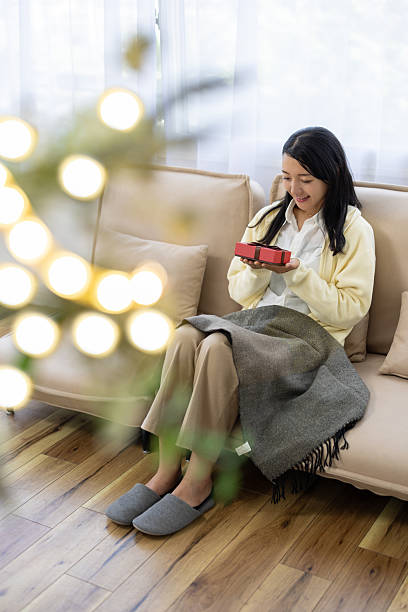 Woman Smiling with Gift Box on Hands