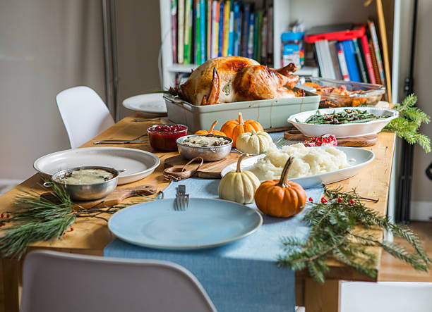 Thanksgiving dinner table with roasted turkey and festive dishes, top view