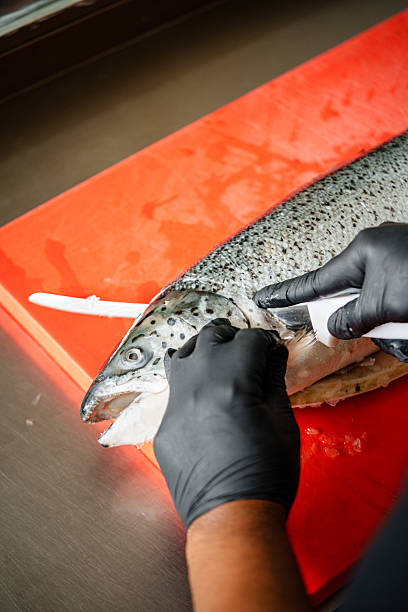 istock Salmon Filleting Process  Chef Cutting Fresh Salmon Fish for Cooking Preparation 2250044845