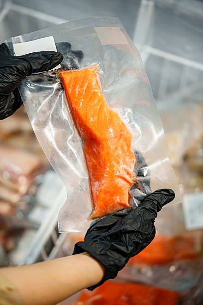 istock Frozen salmon fillet placed on ice, showing fresh texture and bright orange color. 2250044849