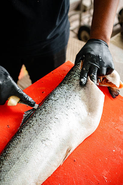 istock Salmon Filleting Process  Chef Cutting Fresh Salmon Fish for Cooking Preparation 2250044920