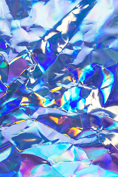 istock Iridescent crumpled foil texture with metallic surface in rainbow colors 2250048052
