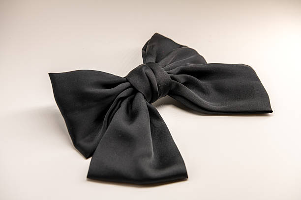 istock Black satin ribbon bow isolated on white, top view 2250049232