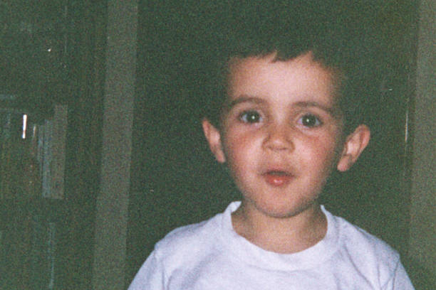istock Image taken in 1988: smiling hispanic little boy looking at the camera posing at his home 2250051483