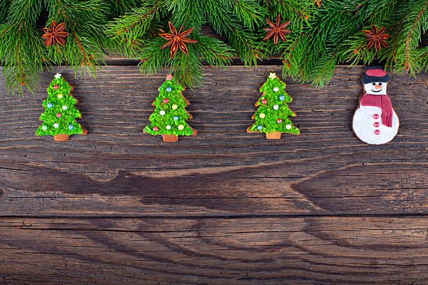 Christmas gingerbread tree cookies and fire tree on rustic wood