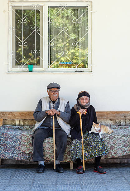 istock Elderly Couple Sitting Outdoors with Cat 2250056368