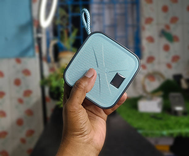 istock Hand Holding a Square Portable Speaker on the Blur Background 2250056875