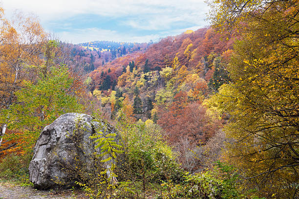 large rock in foreground against beautiful autumn mountains in Bulgaria