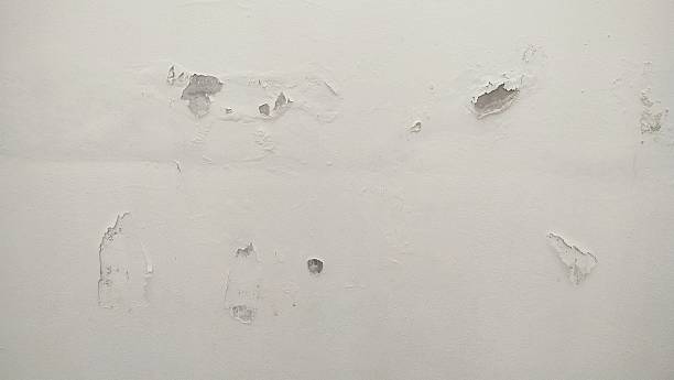 istock The surface or background of an old white wall with peeling paint. 2250063161