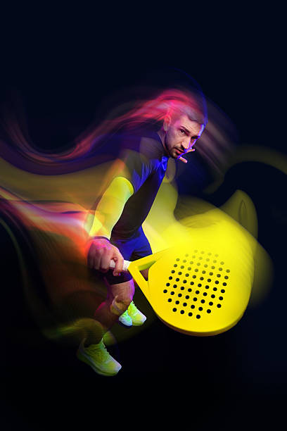 istock Dynamic athlete playing paddle tennis in vibrant colors during an indoor match 2250063740