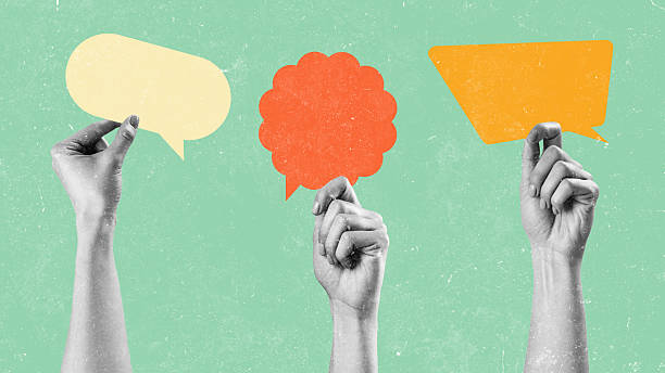 istock Hands holding colorful speech bubbles against a light green background in a creative design setting 2250064141