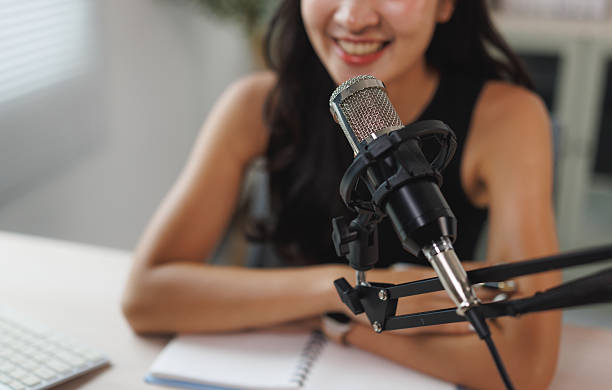 istock Young woman recording online podcast broadcast 2250065627