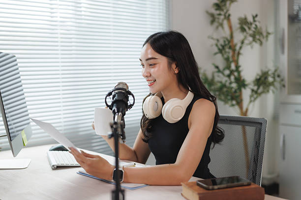 istock Young woman recording podcast at home studio 2250065661
