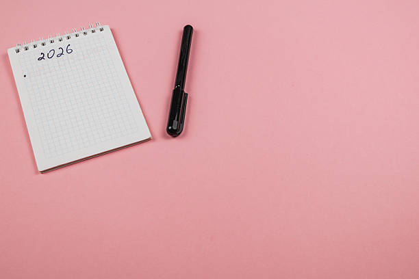 istock Planning for the year 2026 with a notepad and pen on a pink background 2250066011