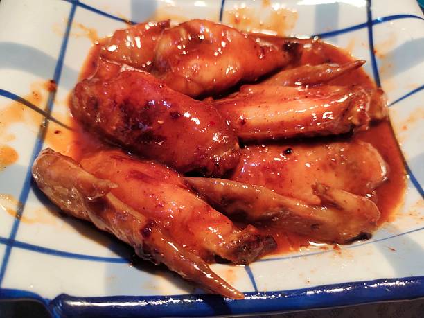 istock Roasted chicken wings coated in a rich, spicy red sauce 2250067976