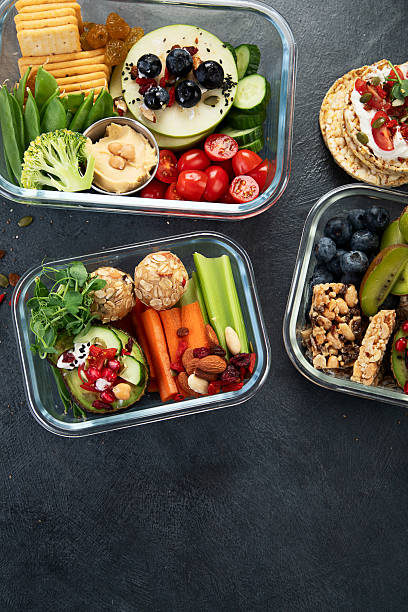 istock Bbox containing fresh fruits, vegetables, sandwiches, and nuts. 2250068019