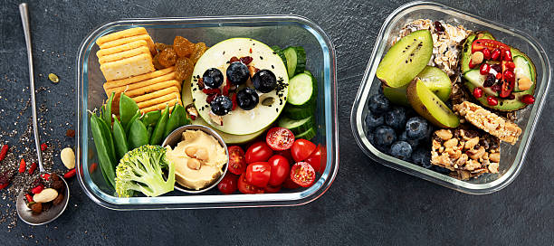 istock Bbox containing fresh fruits, vegetables, sandwiches, and nuts. 2250068247