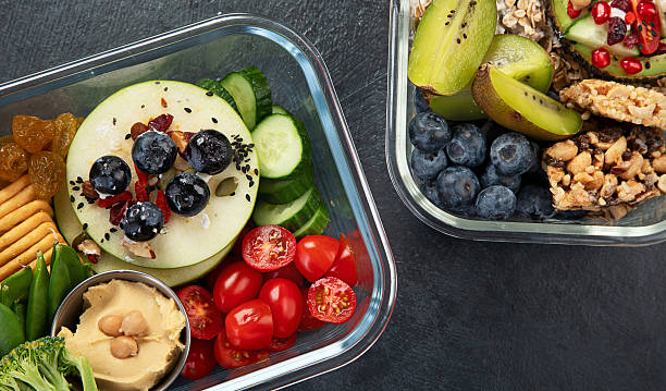 istock Bbox containing fresh fruits, vegetables, sandwiches, and nuts. 2250068788