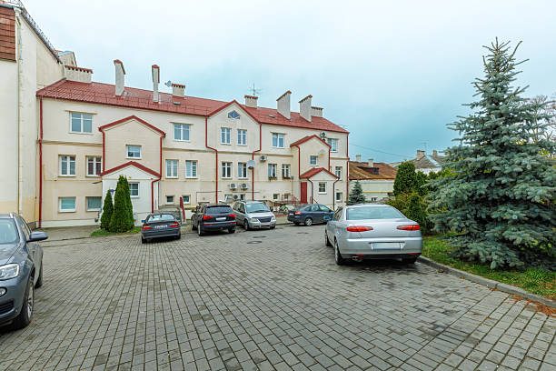 istock Residential Courtyard with Parked Cars and Evergreen Tree 2250071221