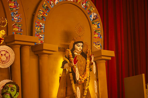A beautifully crafted handmade colorful goddess durga idol decorated for Navratri, featuring vibrant traditional attire, intricate jewellery, and divine expressions at colorful pandal.