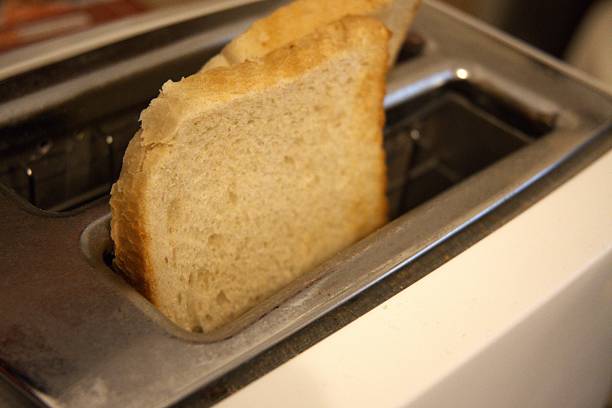 istock 2 Toast Slices in Toaster Close-Up 2250075012