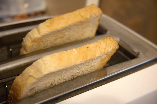 istock 2 Toast Slices in Toaster Close-Up 2250075019