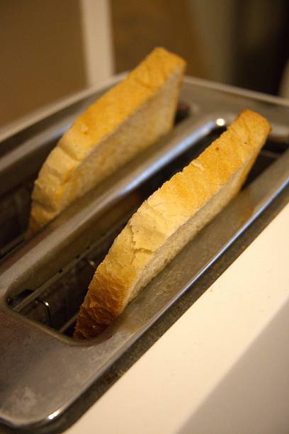 istock 2 Toast Slices in Toaster Close-Up 2250075044