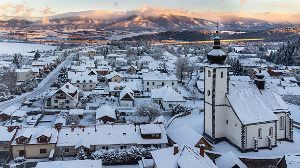 istock Snowy village nestles beneath mountains. 2250076509