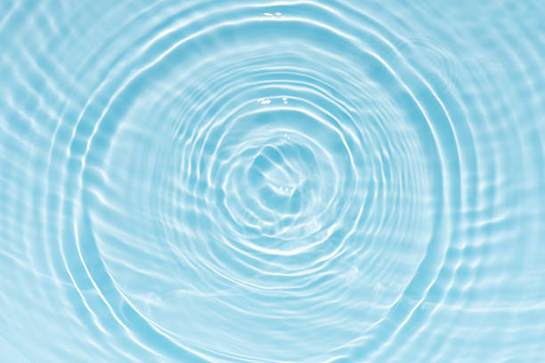 istock Blue water with ripples on the surface. Defocus blurred transparent blue colored clear calm water surface texture with splashes and bubbles. Water waves with shining pattern texture background. 2250076917