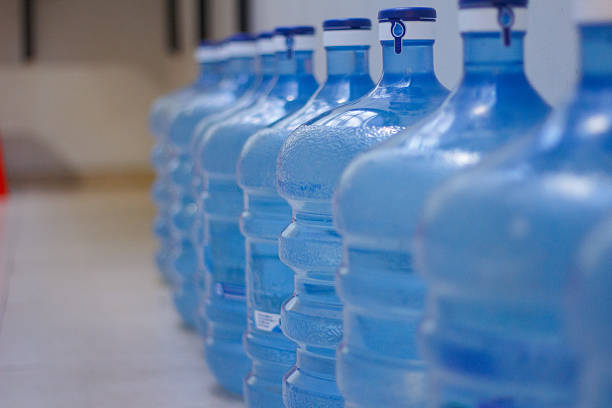 istock Row of Blue Water Gallon Containers in Storage Area 2250077174