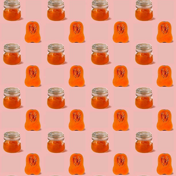 Continuous pattern of pumpkin and pumpkin orange marmalade jar on pink background.
