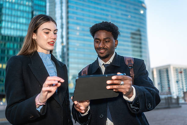 istock Diverse business people discussing outdoor project on digital tablet 2250078136
