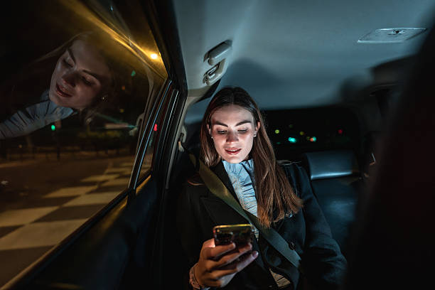 istock Businesswoman using smartphone making call while traveling by car at night 2250078305