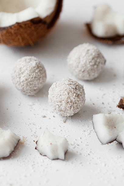 istock Coconut sweets with chocolate on a light wooden background. Natural sweets without sugar. 2250079269